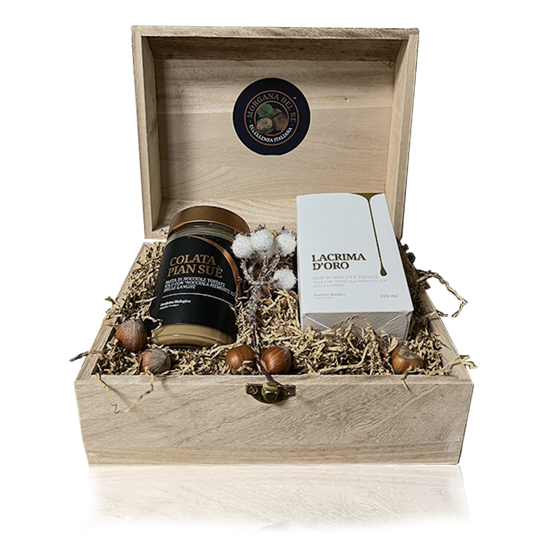 morgana-del-re-confezione-natalizia-baluetto-con-olio-e-pasta-di-nocciola-bio-langhe Immagine del bauletto natalizio morgana del re contenente 1 olio di nocciola da 100 ml e 1 pasta di nocciola
